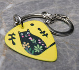 Fat Black Cat with Tilted Head and Flowers on a Yellow Guitar Pick Keychain