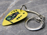 Fat Black Cat with Tilted Head and Flowers on a Yellow Guitar Pick Keychain