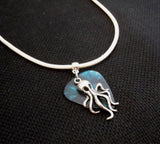 Octopus Charm on a Mottled Teal Guitar Pick Necklace with White Rolled Cord