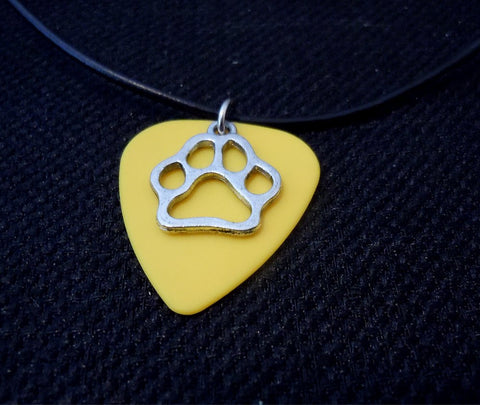 Yellow Guitar Pick with a Paw Print Charm on a Black Rolled Leather Cord Necklace