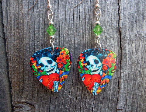 Sugar Skull Surrounded By Flowers Holding a Heart Guitar Pick Earrings with Green Swarovski Crystals