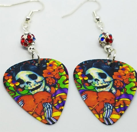 Sugar Skull Surrounded By Flowers Holding a Heart Guitar Pick Earrings with MultiColor Pave Bead