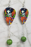 Sugar Skull Surrounded By Flowers Holding a Heart Guitar Pick Earrings with Green Pave Bead Dangles